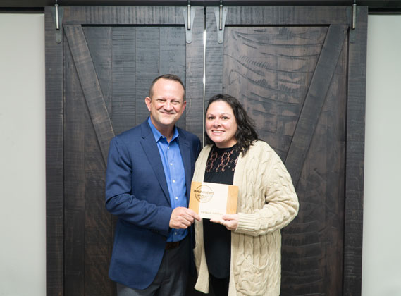 CEO Jim Miller honors Natalie Campos with the Mortise and Tenon Award.